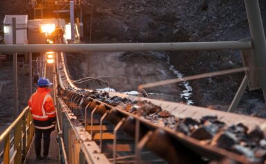 Worker walking wihtin a mining facility